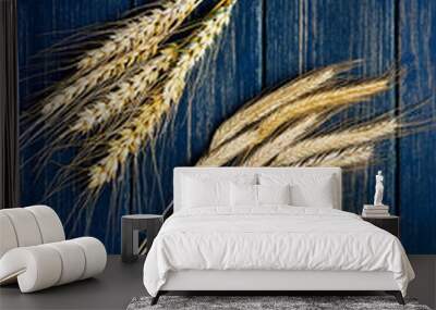 Two types of wheat on a blue wooden board Wall mural