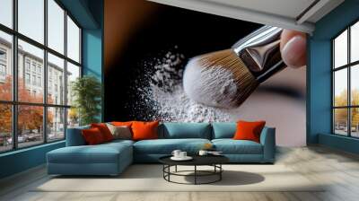 a hand dipping a makeup brush into loose powder, with the soft bristles and fine powder in focus Wall mural