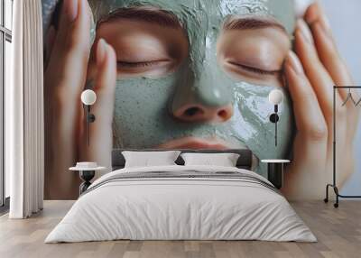 a person's hands applying a hydrating face mask infused with botanical extracts and vitamins, showcasing the indulgence and rejuvenation in at-home skincare treatments Wall mural