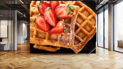 Belgium waffles. Homemade waffles with strawberries, powdered sugar and cup of coffee on black plate on black stone table background. Breakfast. Top view. Mockup for design idea. Wall mural