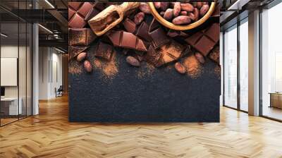 Chocolate . Composition of cocoa powder, grated and bean cocoa bars and pieces of different milk and dark chocolate on black background. Baking Chocolate Texture. Top view with copy space. Mock up. Wall mural