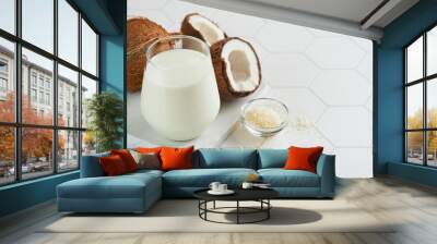 Glass of coconut milk and coconut close up on a white background with space for text. Coconut vegan milk non dairy or Dairy free milk concept. Healthy vegan food. Wall mural