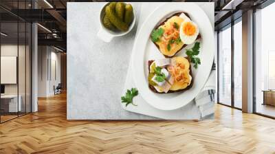 Open sandwich or smorrebrod with rye bread, herring, eggs, caramelized onions, parsley and cottage cheese on old wooden rustic table backgrounds. Danish or Scandinavian traditional food snack lunch. Wall mural