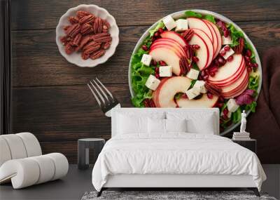 Salad. Fresh fruit green salad with feta cheese, apple, pomegranate, pecan and lettuce on white plate. Idea for healthy delicious winter Christmas salad. Healthy balanced eating. Top view. Wall mural