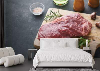 Steaks. Fresh New York Steaks raw with spices rosemary and pepper on black marble board on gray background. Top view. Mock up. Wall mural