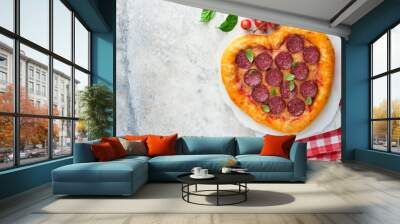 Valentines day heart shaped pizza with mozzarella, pepperoni and basil, wine bottle, two wineglass, gift box on light grey background. Idea for romantic dinner Valentines day. Top view. Mock up. Wall mural