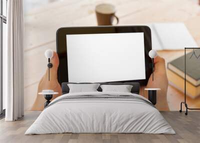 man hand using tablet computer on wooden table Wall mural