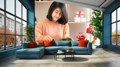 young asian woman prepare decorating for christmas and new year celebration Wall mural