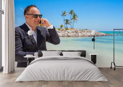 Businessman talking on phone at the beach Wall mural