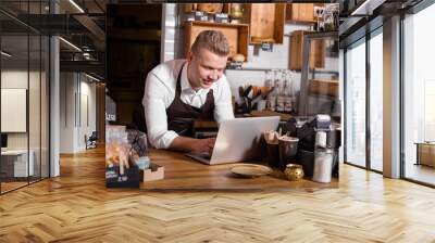 Cafe owner working on laptop behind the counter Wall mural