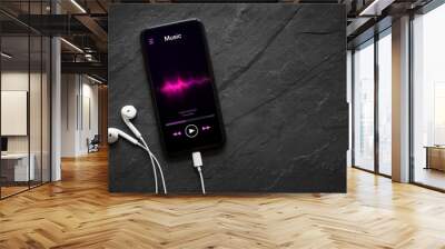 Music player on mobile phone with earphones Wall mural