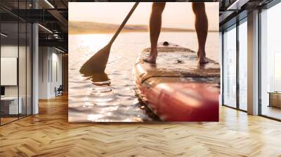 Person on paddle board at sunset Wall mural