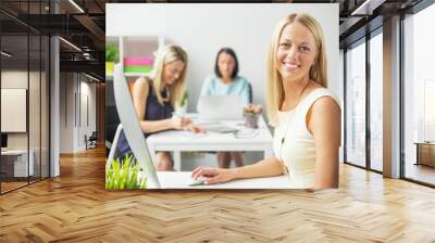 Smiling women working in the office Wall mural