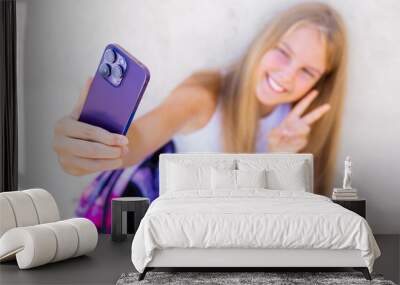 Teenage girl taking selfie with mobile phone Wall mural