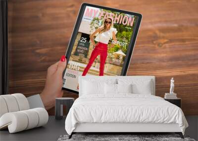 Woman reading digital edition of fashion magazine on tablet computer Wall mural