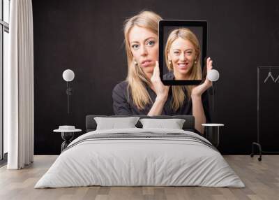 Woman showing happy portrait on tablet Wall mural