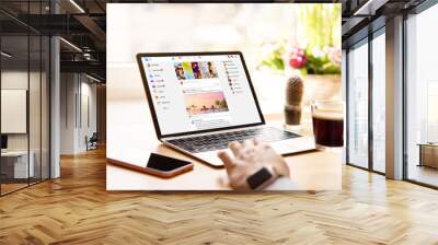 Woman using social media on laptop computer Wall mural