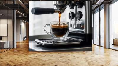 A fresh cup of coffee being poured from a coffee machine into a large glass mug, with steam rising, isolated on white. Wall mural