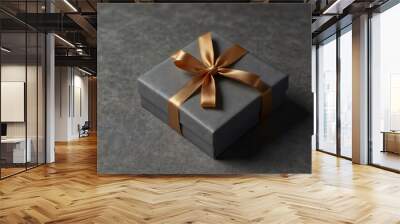 A gift box with an inscription on a gray background. Wall mural