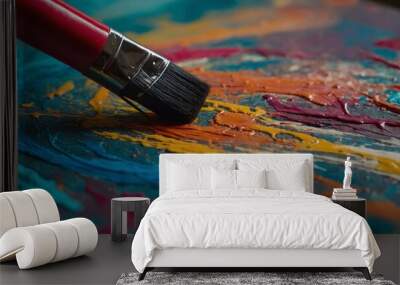 Close-up of an artist's brush creating abstract art on a vibrant canvas. Wall mural