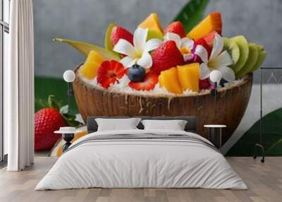 Fruit salad in a coconut bowl with flowers, tropical theme. Wall mural