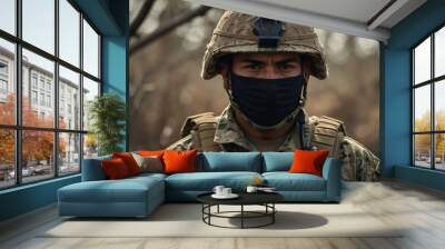 Hispanic soldier in camouflage uniform at conflict. Wall mural