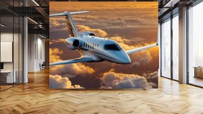 Private jet flying above clouds during a golden sunset. Wall mural