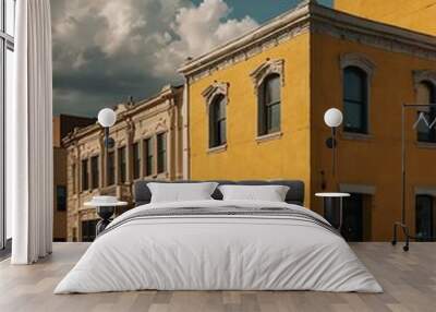 Small town with downtown architecture and a yellow wall. Wall mural