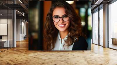 Portrait of a young beautiful smiling woman wearing glasses Wall mural