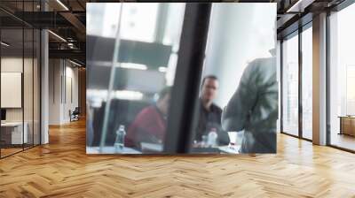 Businessman making a presentation at office. Business team leader delivering a presentation to his colleagues during meeting or in-house business training. Wall mural