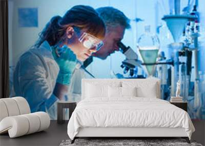 health care researchers working in life science laboratory. young female research scientist and seni Wall mural