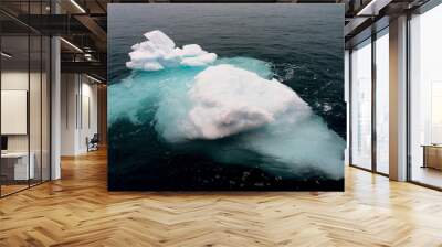 floating iceberg partially submerged with aqua ice in Greenland Wall mural