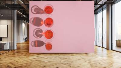 Pastel pink arrangement made of party cocktail and wine glasses on pink background. Romantic and girly minimal concept. Wall mural