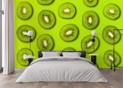 Slice of green raw kiwi fruit pattern background. Flat lay, trendy juicy color. Wall mural