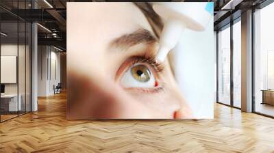 woman applying eye drop. vitamin drops from tiredness and redness eyes. suffering from irritated eye Wall mural