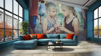 two thirsty girls drinking refreshment drink Wall mural