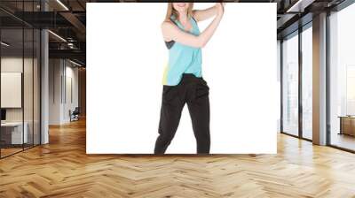 Young, pretty natural looking girl in sport t -shirt and jogging pants having fun dancing. Full body studio shot, pure white background. Wall mural