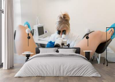 A gynecologist examines a patient on a gynecological chair. Workflow of a gynecologist Wall mural