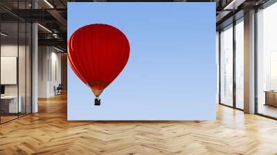 A red hot-air balloon in the sky on a beautiful summer morning. Wall mural