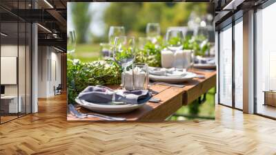 Beautifully decorated wooden table in a summer open-air cafe. Green branch and fresh flowers table decoration Wall mural