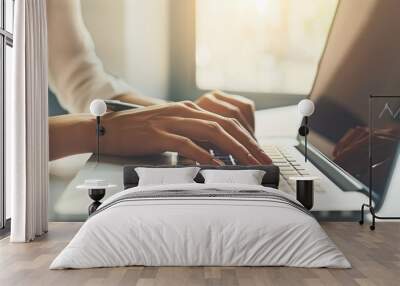 female hands typing on laptop in bright office Wall mural