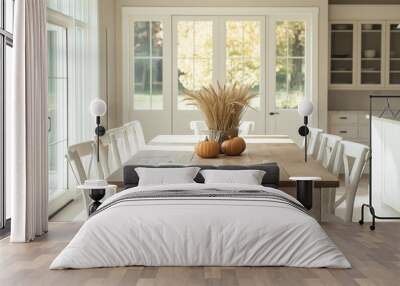 A warm farmhouse dining room with a wooden table, white chairs, and a fall decor centerpiece Wall mural