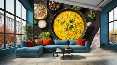 Delicious healthy broccoli cream soup on dark rustic background. Rich of antioxidants. Top view Wall mural