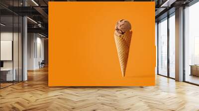 Ice cream cone with caramel flavors on a pink background Wall mural