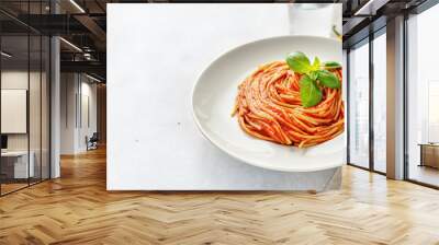 Pasta with tomato sauce and basil on white background Wall mural