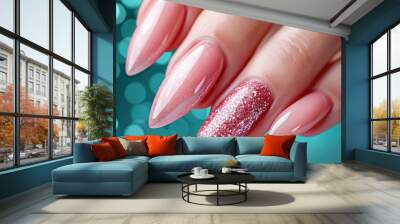 A woman's hand with a neat manicure and soft pink nail polish. Wall mural