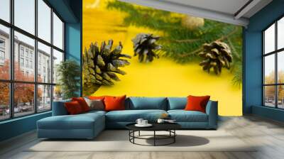 christmas tree branch with cones on yellow background. happy new year 2021. merry christmas. Wall mural