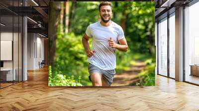 Man jogging in the forest. Outdoor sports. Healthy lifestyle. Young man in a white T-shirt and sports shorts. Wall mural