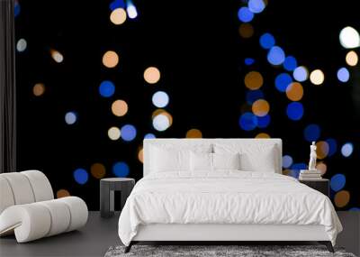 Blue and yellow festive bokeh lights on black background Wall mural