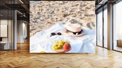 Summer picnic on the beach by the sea at a sunrise. Picnic with fresh ripe summer fruits. Wall mural